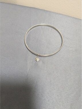Silver bangle bracelet with charm